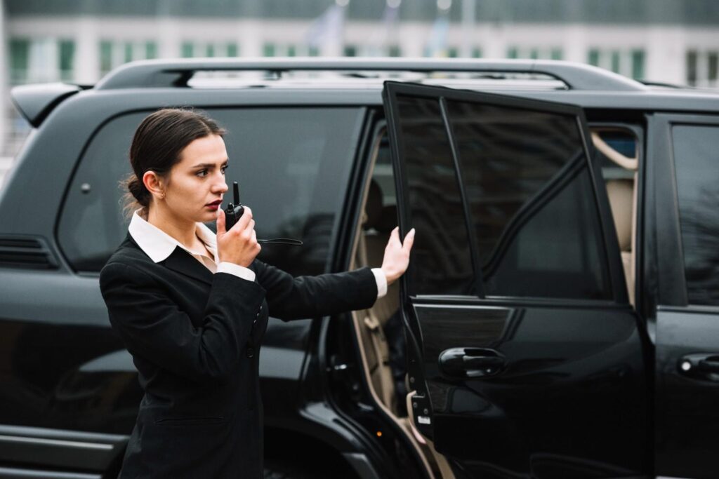 female agent maintaining contact with security headquarter during VIP protection services protocol