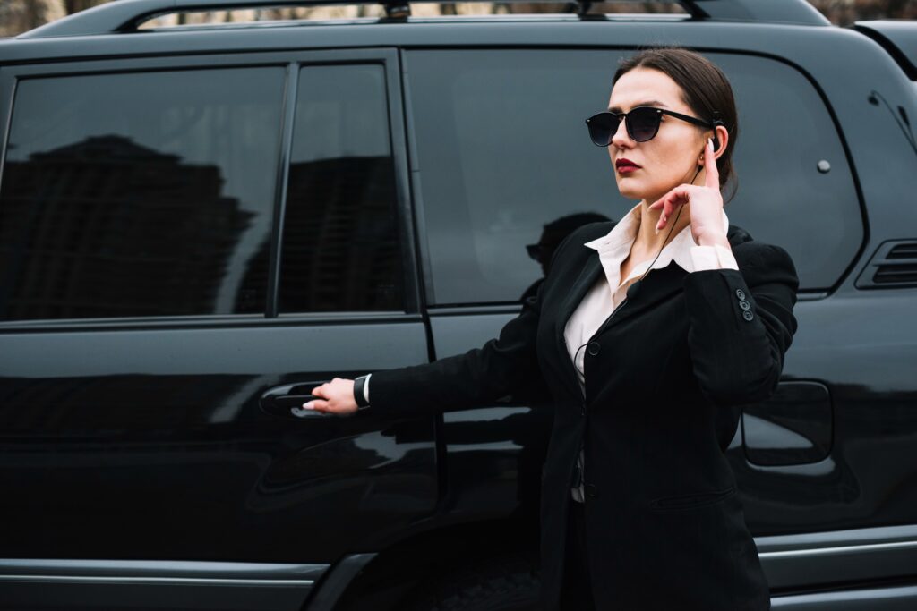 a female agent standing guard, providing elite security & protection service
