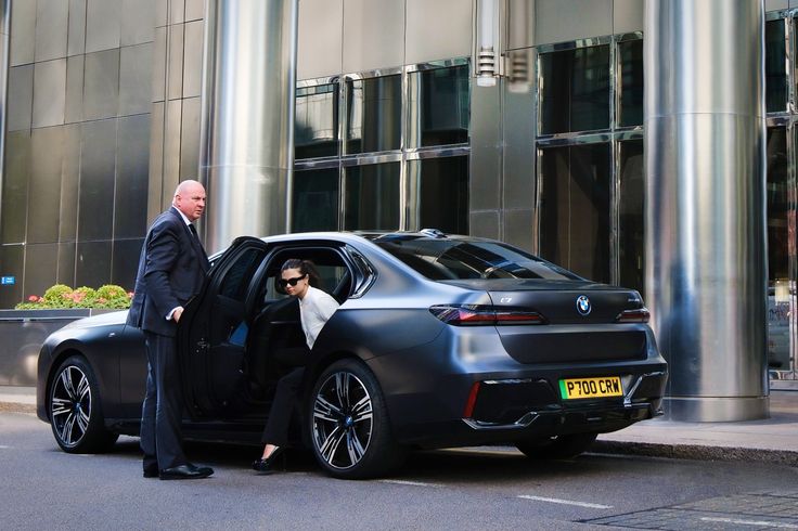 luxury lifestyle security - corporate billionaire client getting out of car
