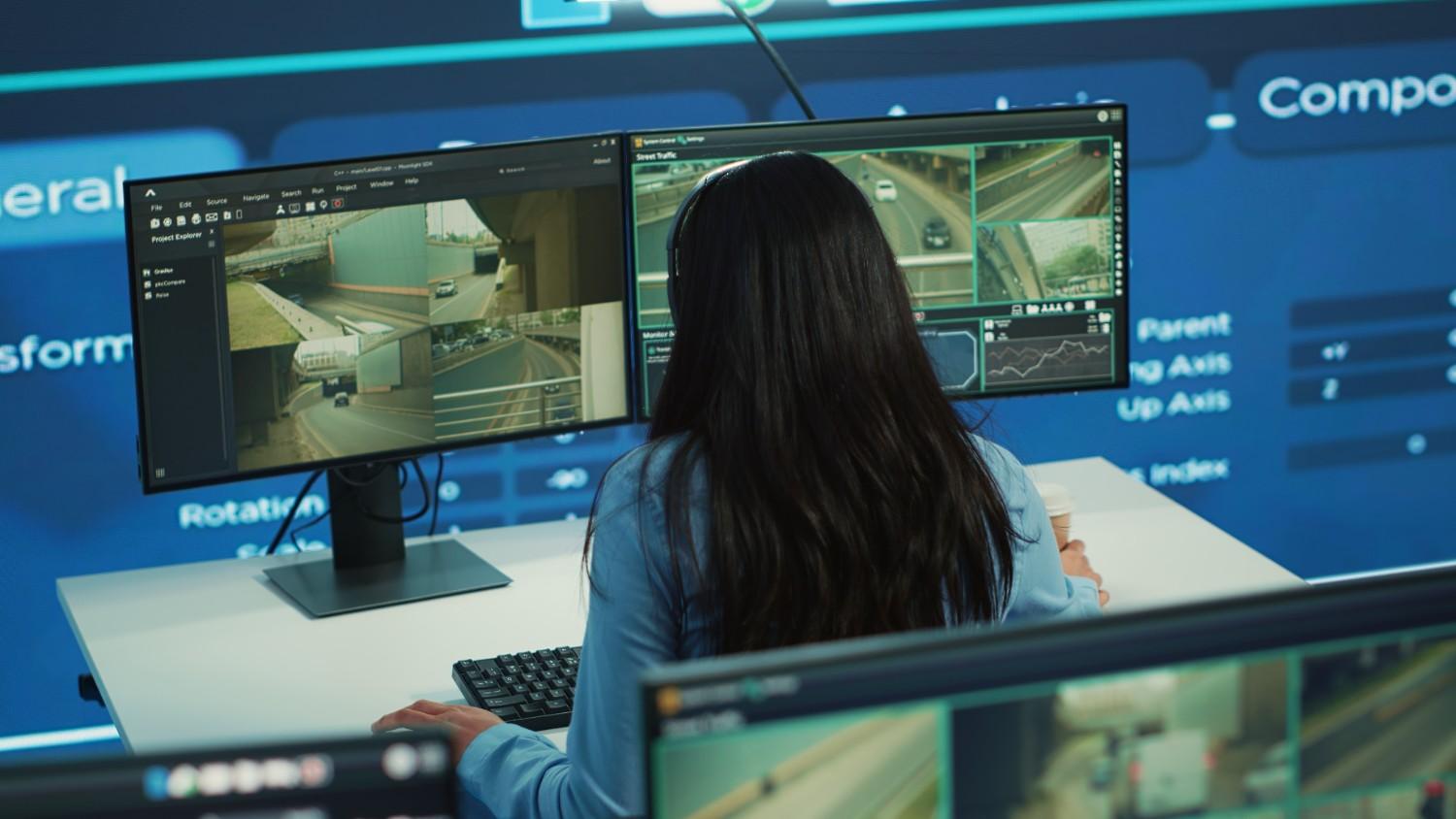 technical & systems integration for security - woman looking at cctv video footage