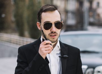 an elite security agent communicating over walkie-talkie